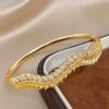 41122 - Pulsera acero dorado multiespigas con cristal