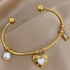 41105 - Pulsera Acero dorada multi dije