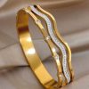 41150 - Pulsera acero dorada ondas con cristales