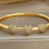 41200 - Pulsera acero dorado tri corazon con cristales