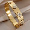 41229 - Brazalete acero dorado estrella corazon con cristales